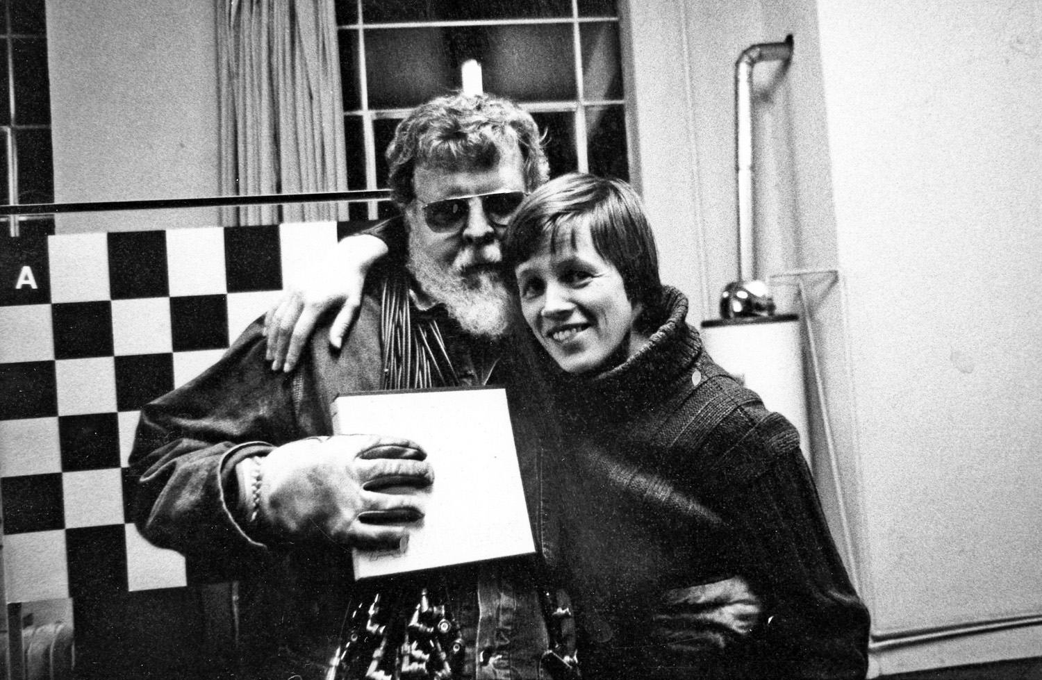 Black and white photo of two people smiling